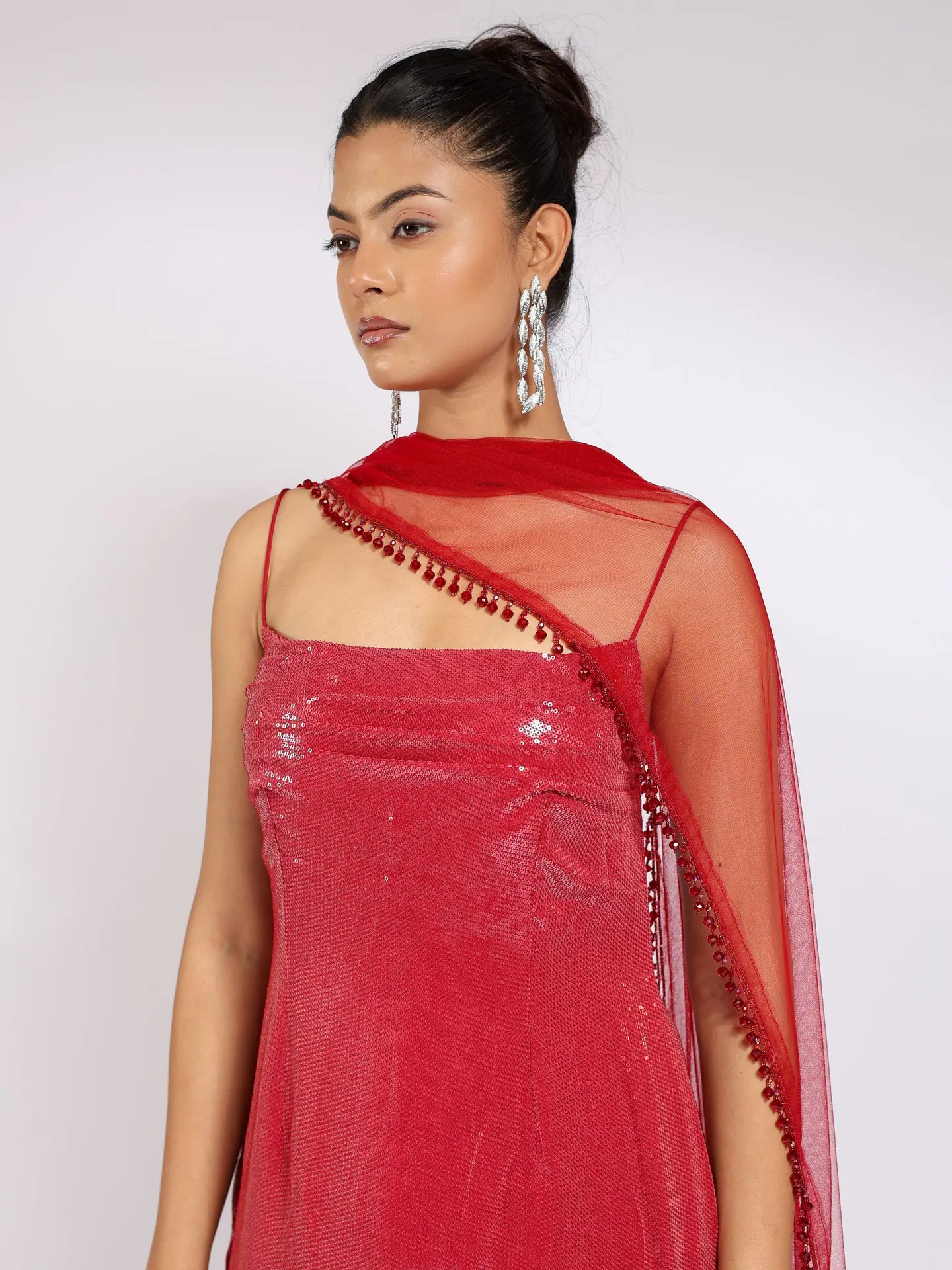Crimson sequin kurta, dupatta over one shoulder, waist-up