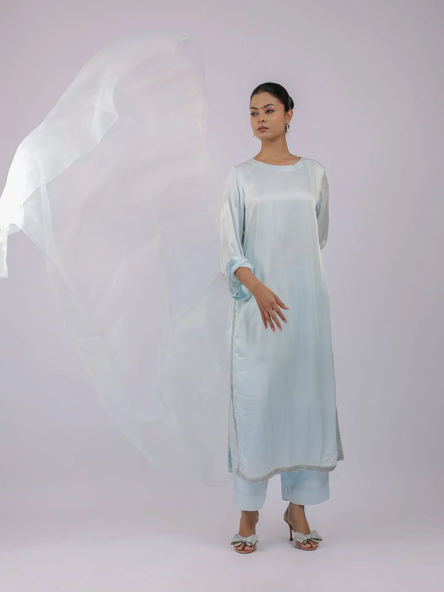 Ice-blue satin kurta with organza dupatta lifted in the air