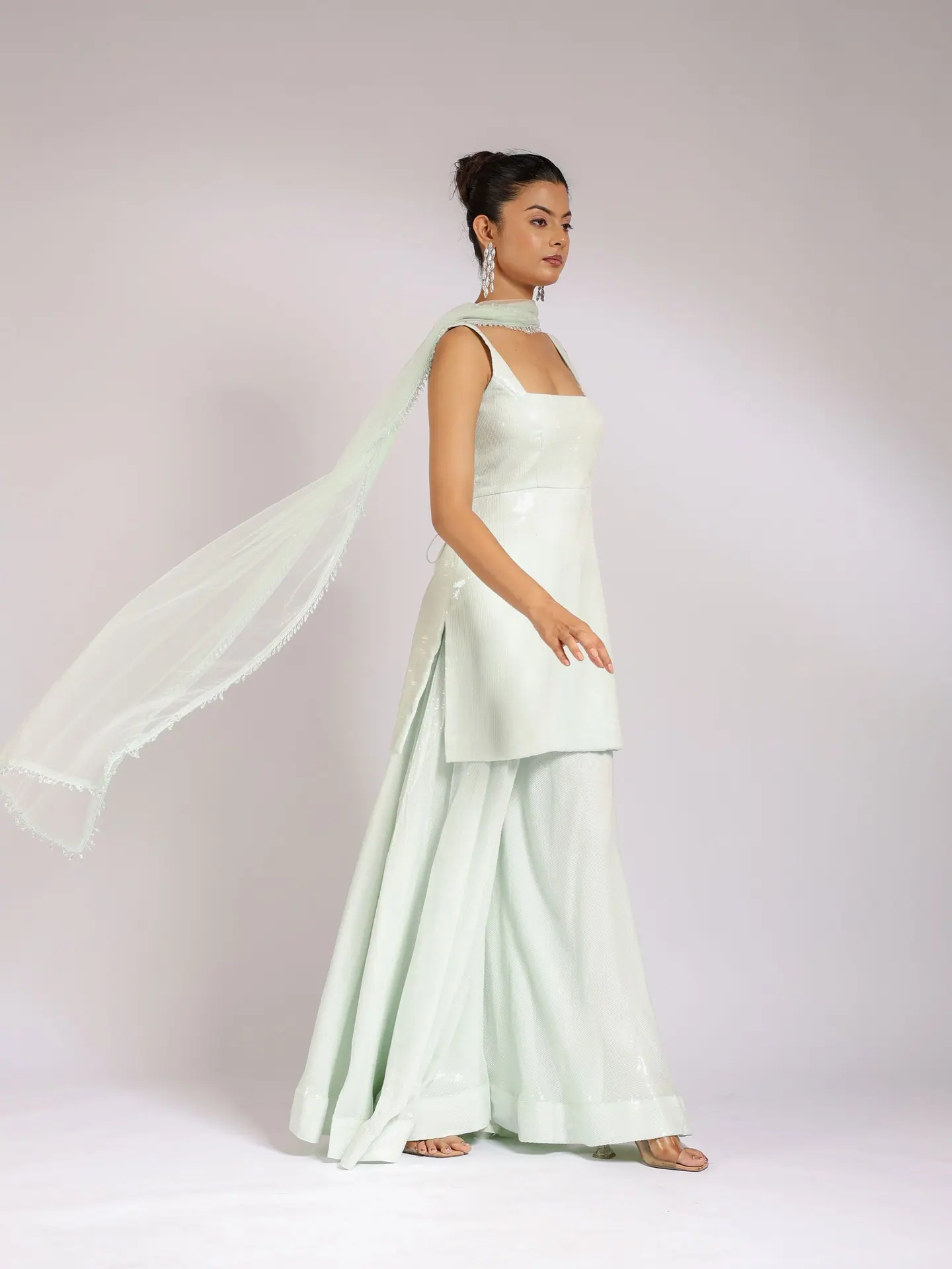 Mint sharara set with the dupatta lifted in the air