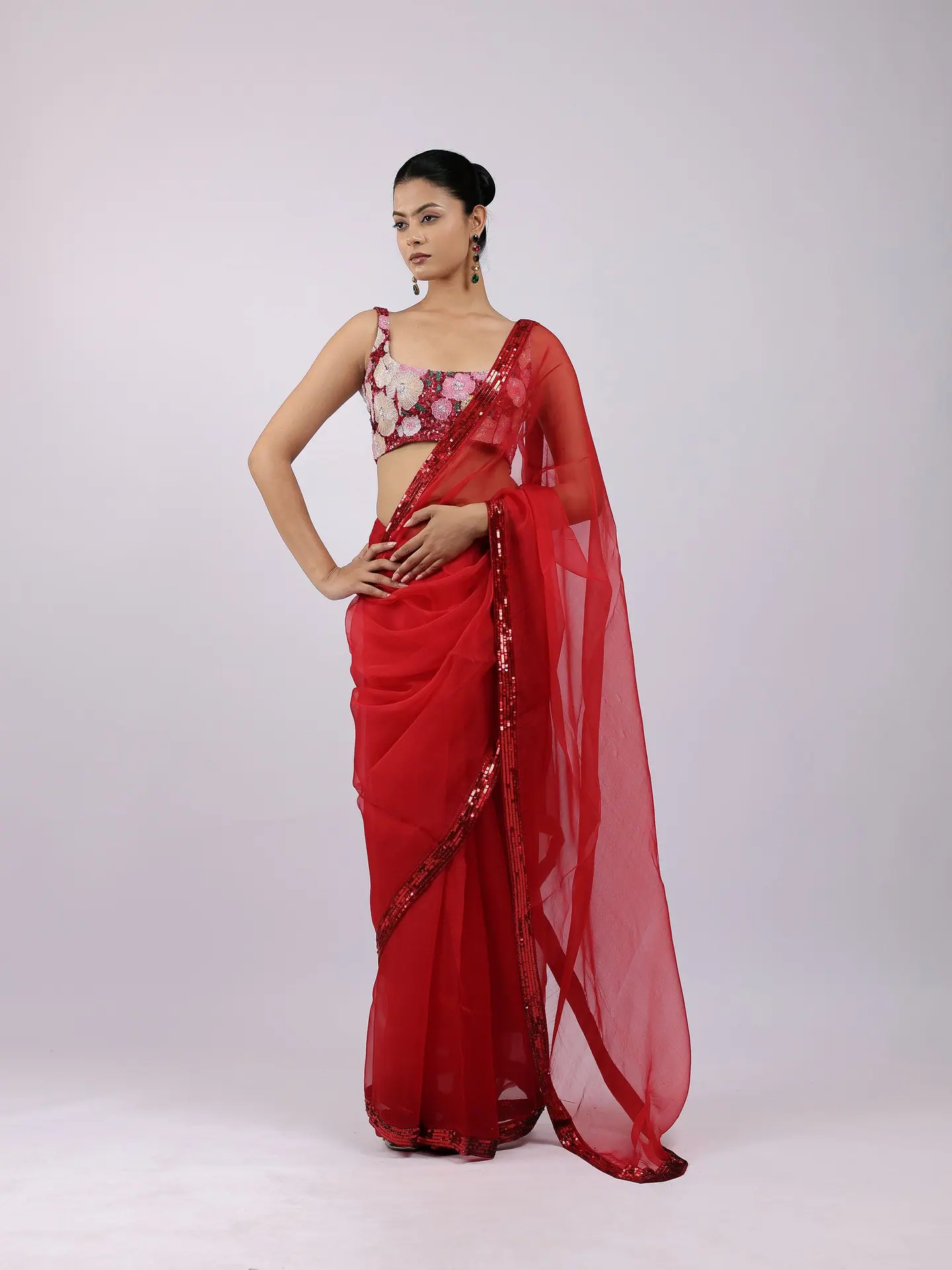 Red organza saree with an embroidered blouse, full length